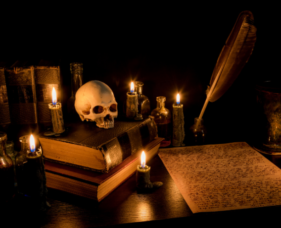 books, parchment, pen, ink, skull