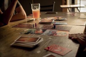 People playing a board game at a café table, capturing leisure and social interaction.