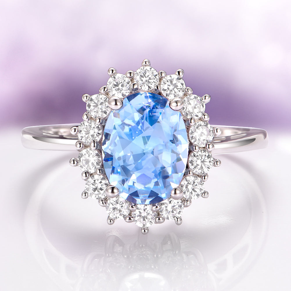 Oval aquamarine engagement ring with a pave halo in sterling silver